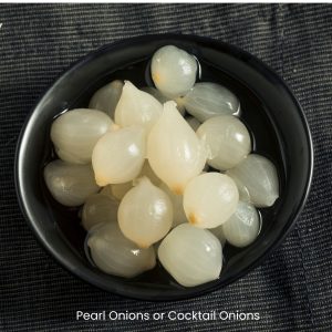 small black bowl showing pearl onions that have been pickled.