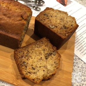 Banana bread sliced on a wooden board.