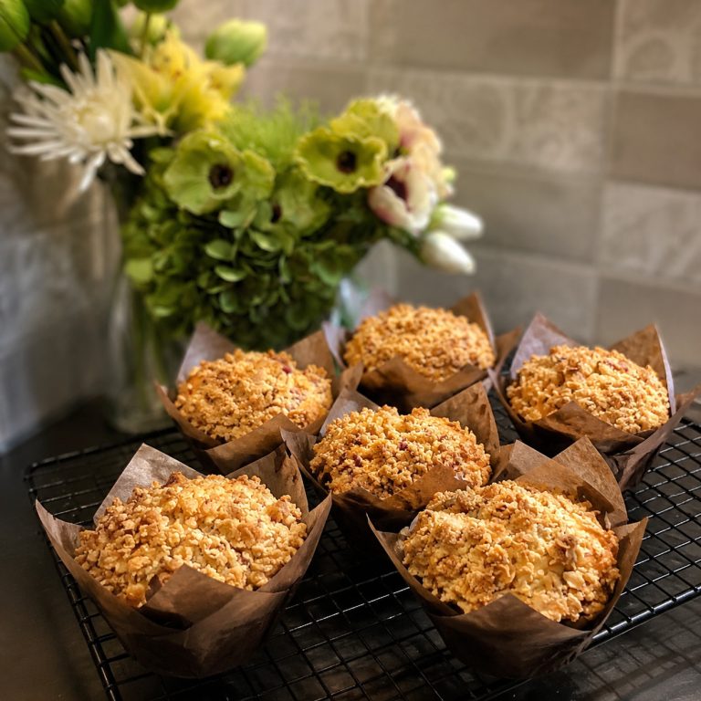 Apple crumble muffins sitting on a cooling rack.