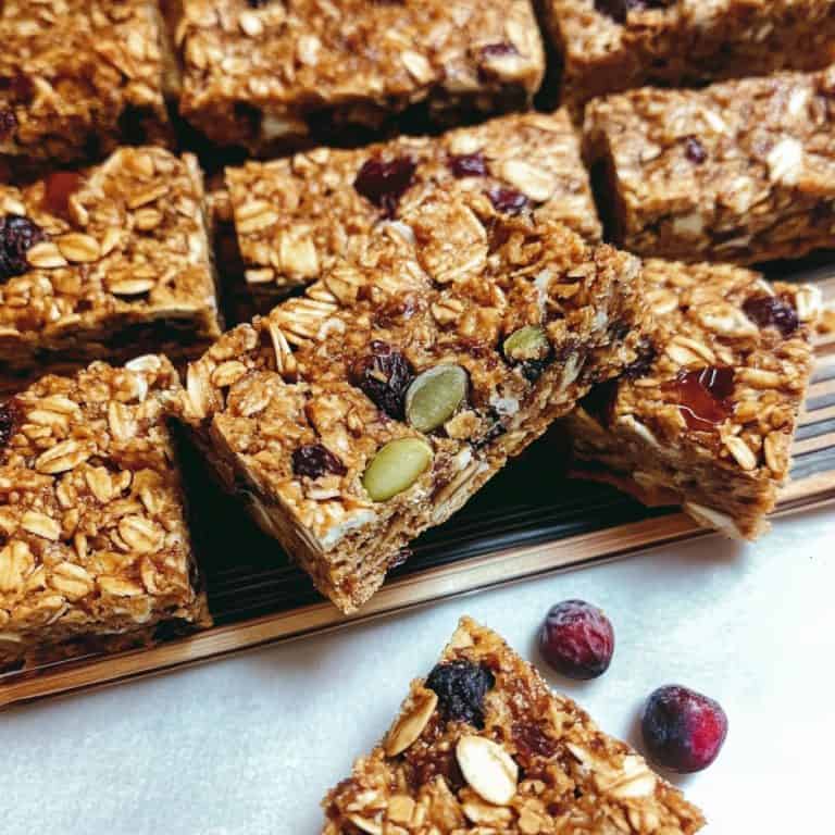 Homemade muesli bars sliced into rectangles sitting on a USA baking pan.