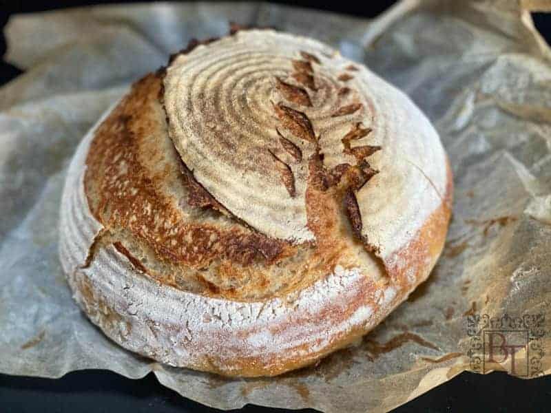 Round wholemeal sourdough on baking paper.