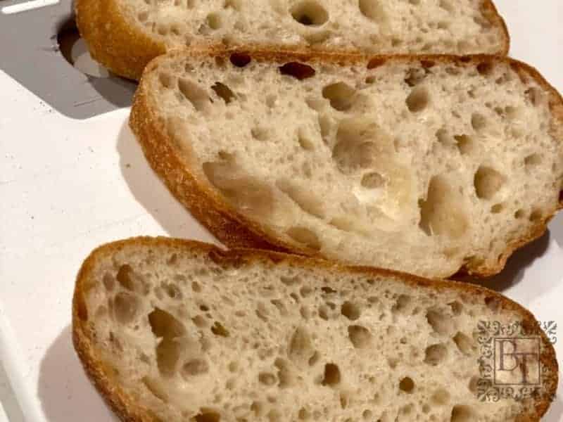 Sliced sourdough bread showing the holes formed by the expanding gases during fermentation.