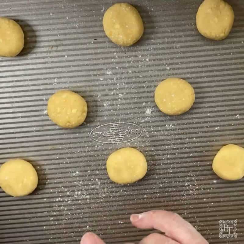 A baking tray with cookie portions showing how to place them for baking.