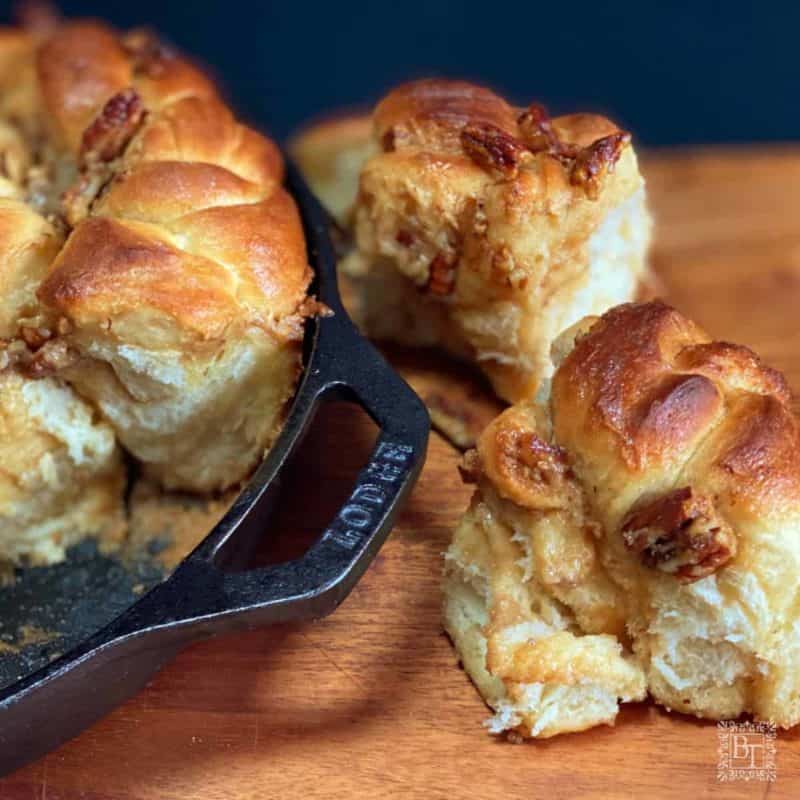 Pecan and caramilk scrolls in a iron skillet.