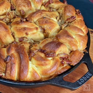 A cast iron skillet with Pecan and Caramilk skillet scrolls.