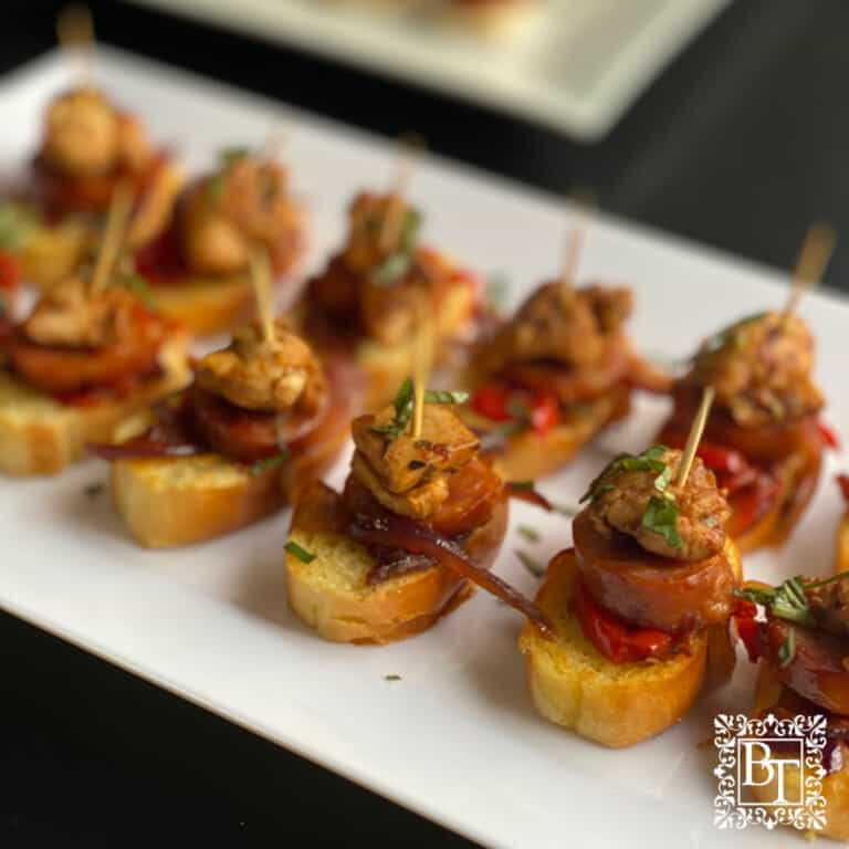 White rectangle plate with Chicken and Chorizo Bites.