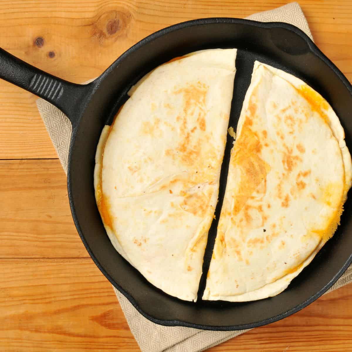 Two Quesadilla in a frypan.