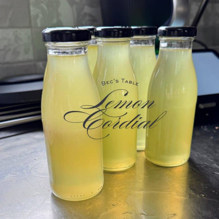 6 glass bottles filled with homemade lemon cordial.